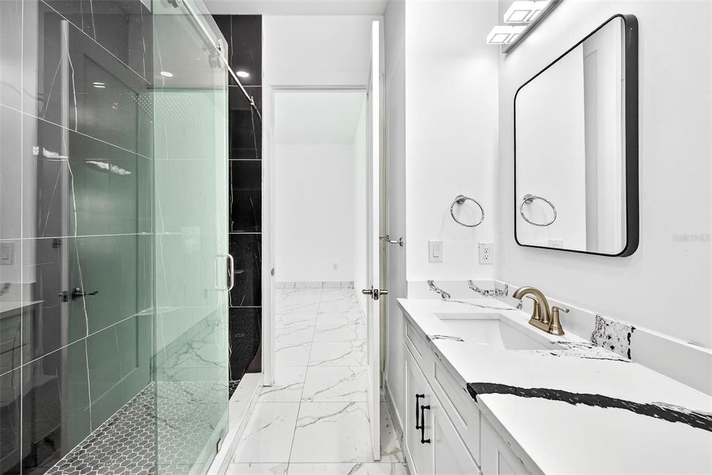 216 North Glen Arven Avenue Temple Terrace, FL 33617 - Photo 14 of 61 a bathroom with a double vanity sink mirror and shower