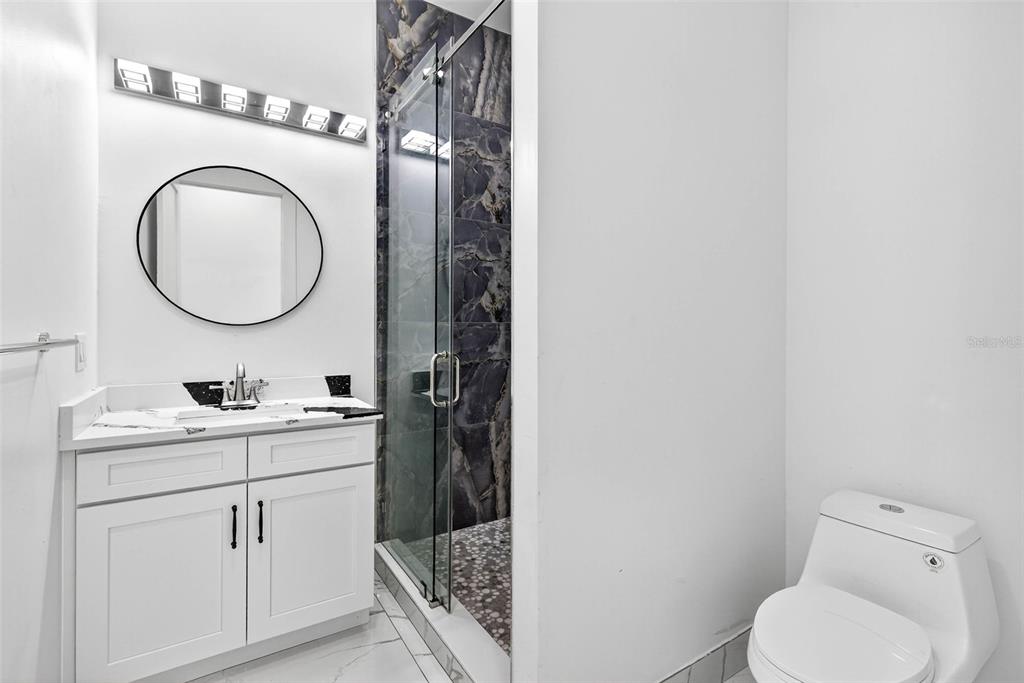 216 North Glen Arven Avenue Temple Terrace, FL 33617 - Photo 15 of 61 a bathroom with a toilet a sink and a mirror