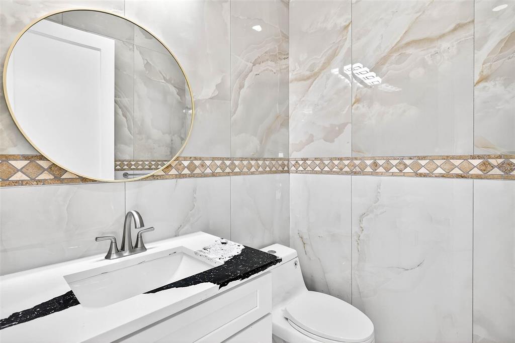 216 North Glen Arven Avenue Temple Terrace, FL 33617 - Photo 17 of 61 a bathroom with a sink vanity granite and toilet