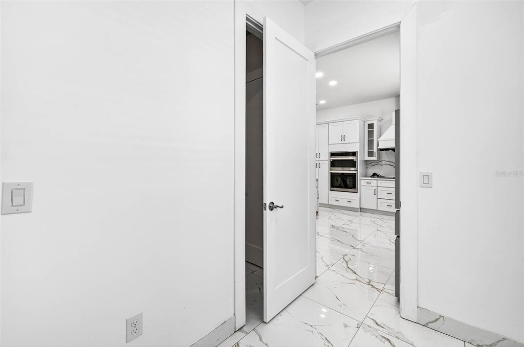 216 North Glen Arven Avenue Temple Terrace, FL 33617 - Photo 18 of 61 a view of a hallway with wooden floor