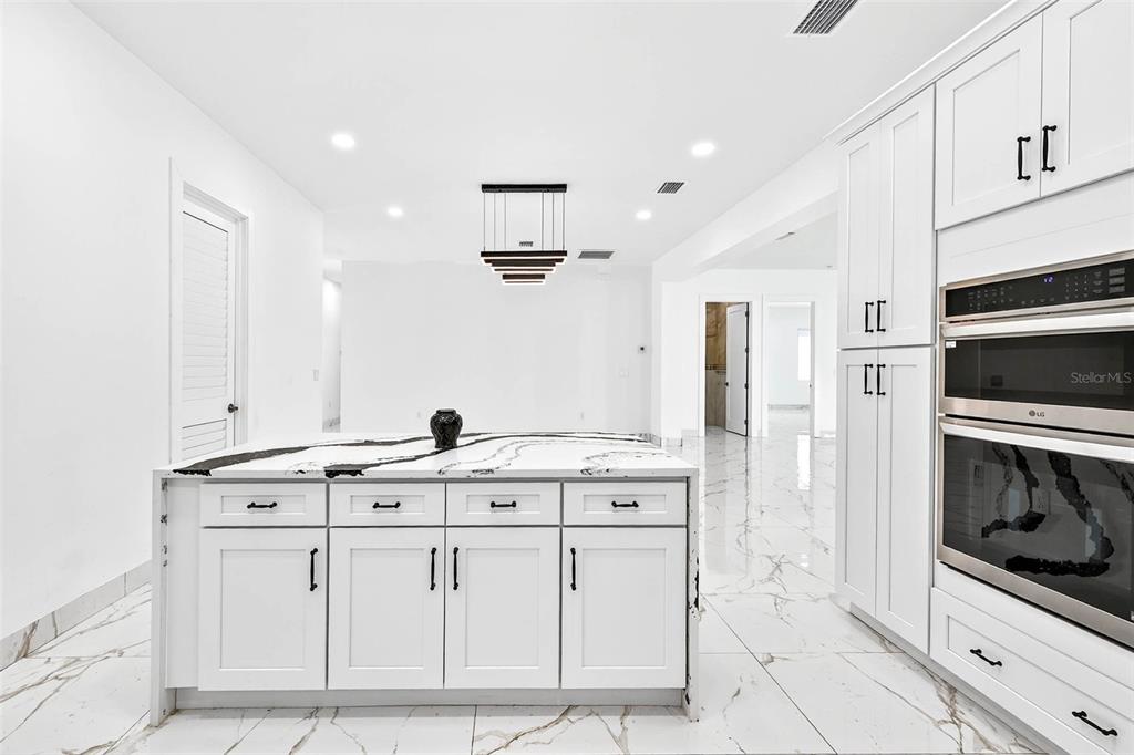 216 North Glen Arven Avenue Temple Terrace, FL 33617 - Photo 32 of 61 a kitchen with stainless steel appliances granite countertop a sink and a stove