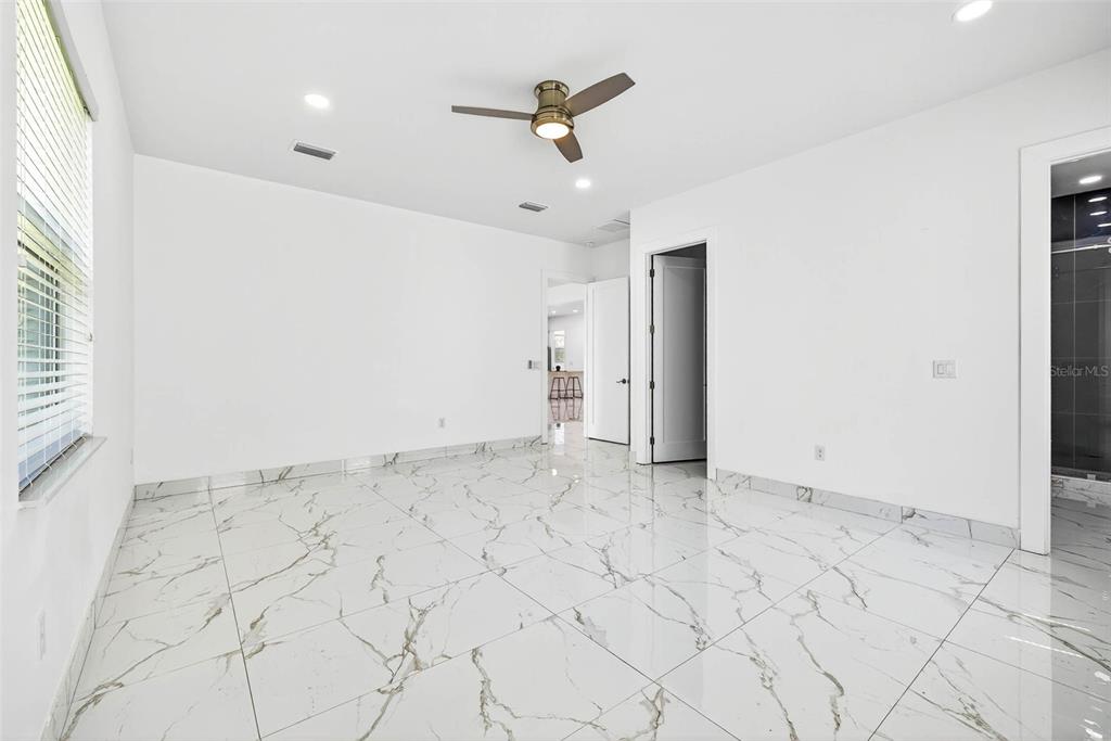 216 North Glen Arven Avenue Temple Terrace, FL 33617 - Photo 42 of 61 an empty room with white walls and ceiling fan