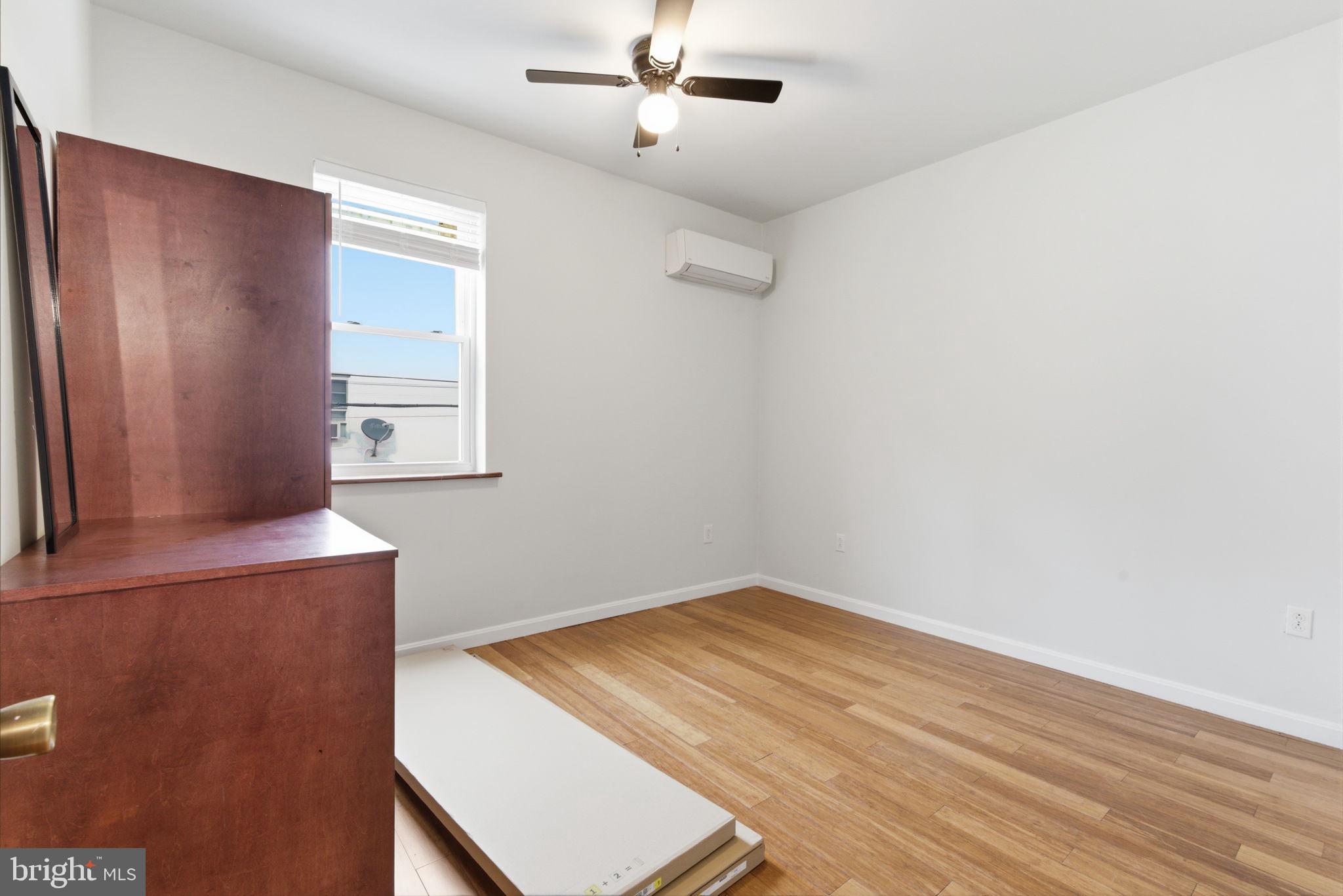 1926 South 7th Street, Unit 2 Philadelphia, PA 19148 - Photo 11 of 18 an empty room with wooden floor closet and windows