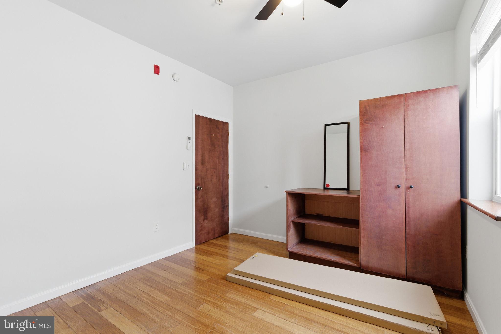 1926 South 7th Street, Unit 2 Philadelphia, PA 19148 - Photo 12 of 18 a view of an empty room with wooden floor and a window