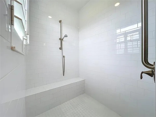 a bathroom with a bathtub and shower