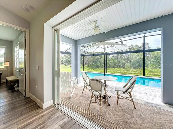 a view of a room with wooden floor and outdoor seating