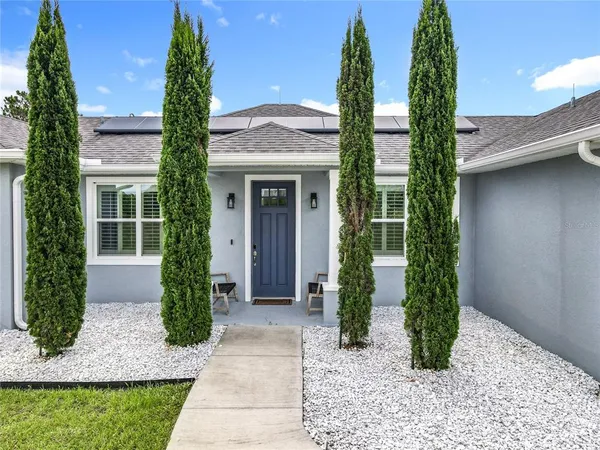 a front view of a house with garden