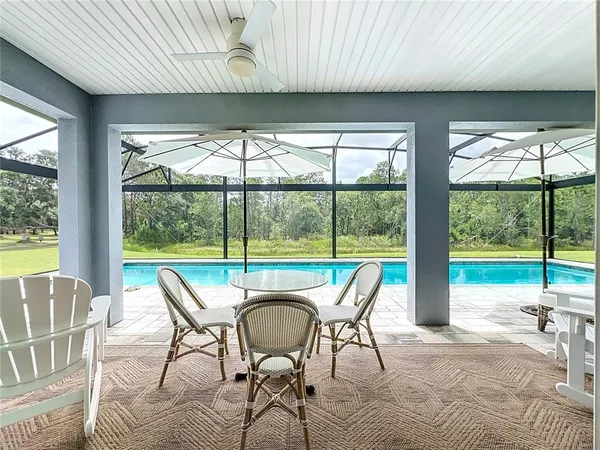 a living room with hardwood floor and balcony