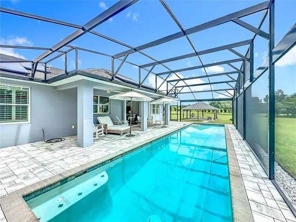 a view of swimming pool with a patio