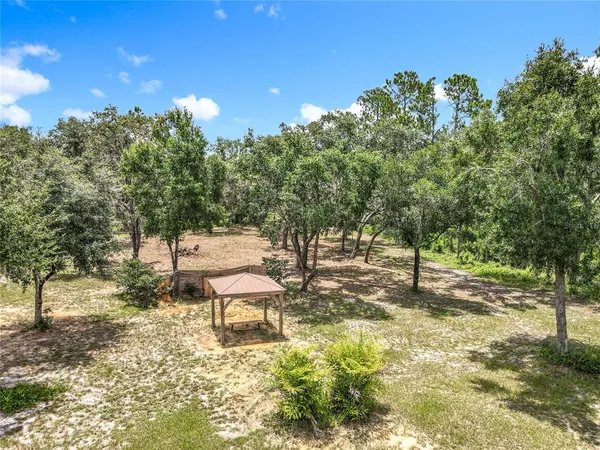 a backyard of a house with table and chairs