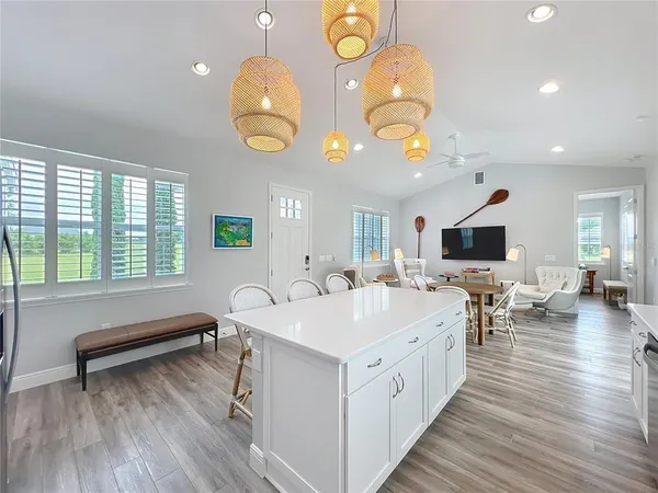 a large white kitchen with a large island