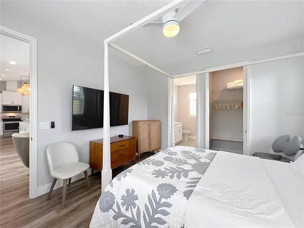 a bedroom with a bed and a flat screen tv