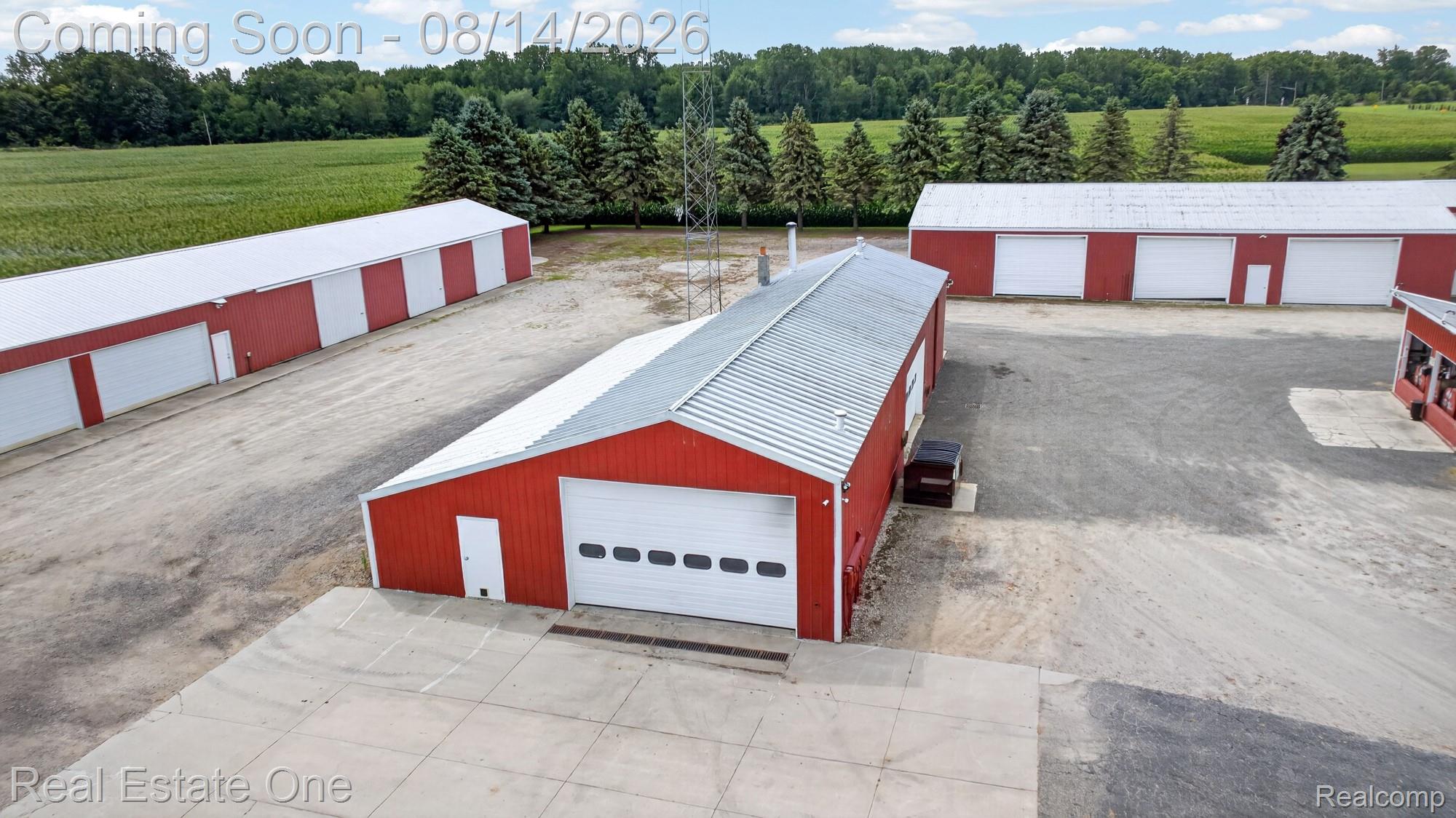 12139 Gooding Road Milan, MI 48160 - Photo 77 of 98 Multiple red structures featuring white roll-up garage doors and white entry doors