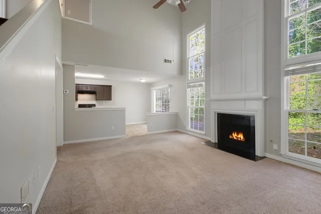 a view of a livingroom with a fireplace and window