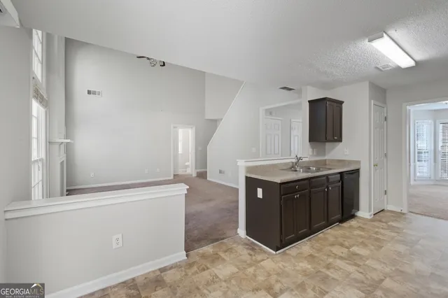 a kitchen with stainless steel appliances granite countertop a sink and a stove top oven