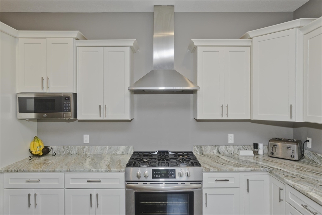 14 Ralph Street Springfield, MA 01109 - Photo 12 of 41 a kitchen with stainless steel appliances granite countertop a sink a stove and a granite counter tops