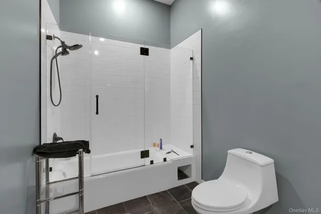 a bathroom with a toilet sink and shower