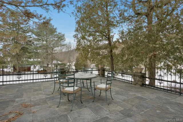 a view of a patio with a table and chairs