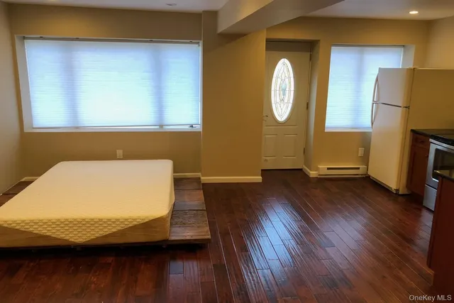 a room with wooden floors and a bed