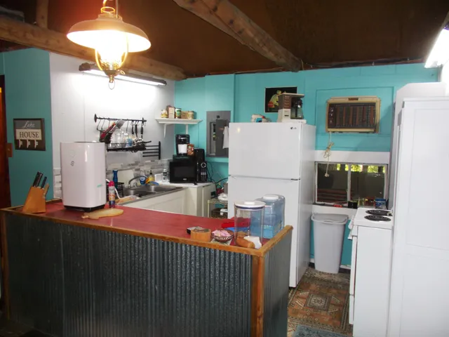 a kitchen with refrigerator and cabinets