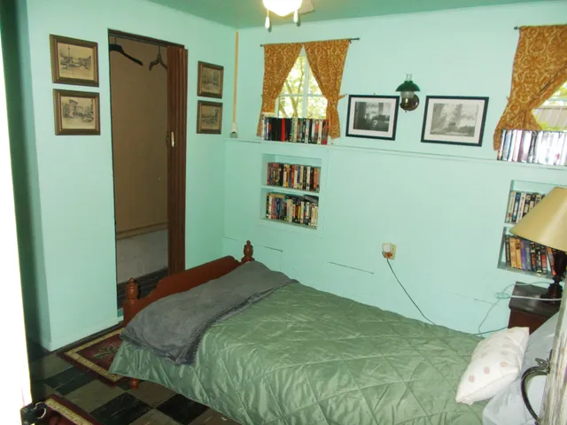 a room with cabinets and wooden closet