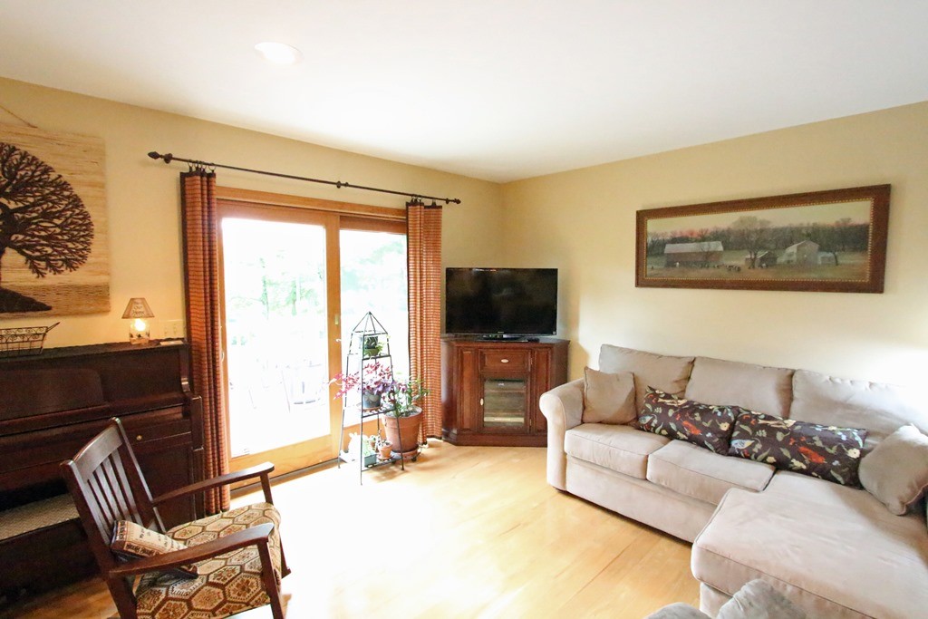 39 Harlow Clark Road Huntington, MA 01050 - Photo 13 of 30 a living room with furniture a flat screen tv and a large window