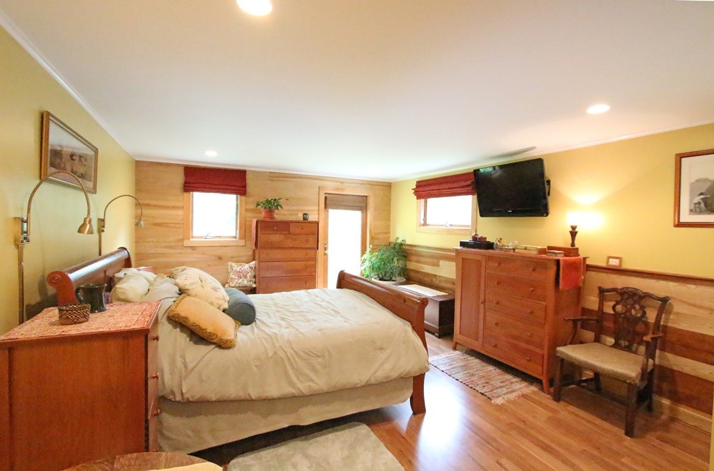 39 Harlow Clark Road Huntington, MA 01050 - Photo 16 of 30 a bedroom with a bed and wooden floor