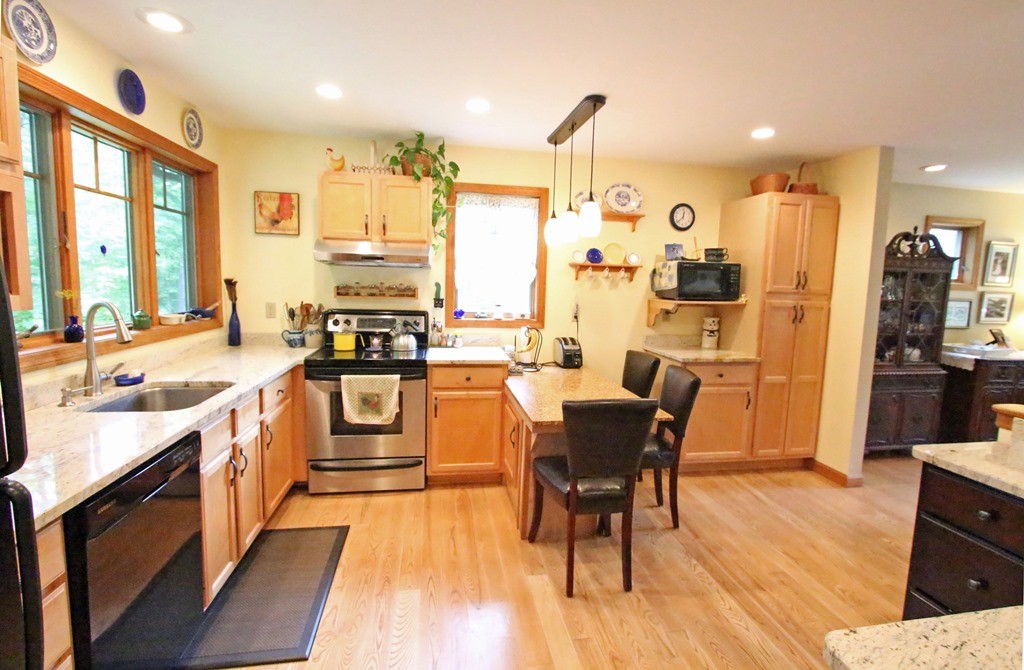 39 Harlow Clark Road Huntington, MA 01050 - Photo 5 of 30 a kitchen with stainless steel appliances a stove a sink dishwasher a refrigerator and cabinets with wooden floor