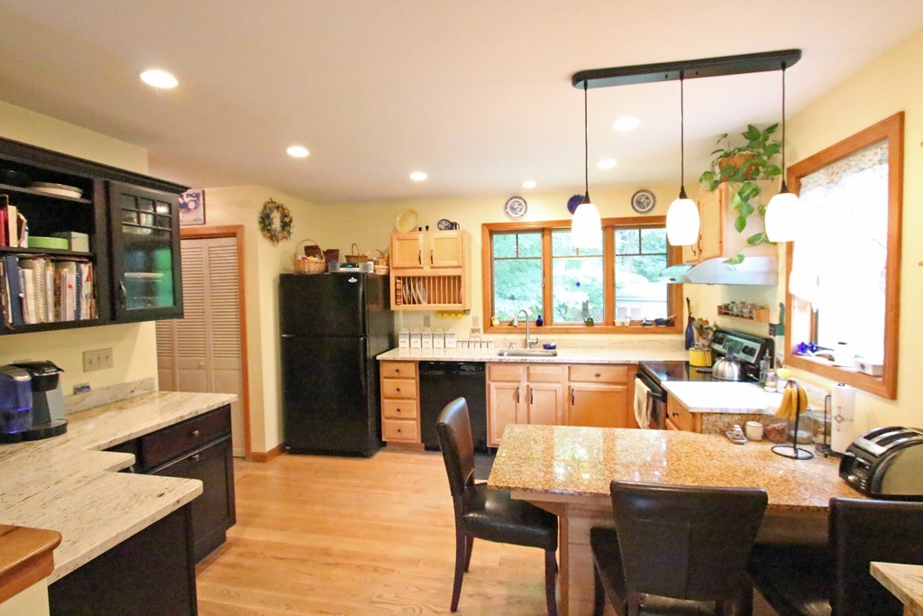 39 Harlow Clark Road Huntington, MA 01050 - Photo 6 of 30 a kitchen with a table chairs refrigerator and cabinets