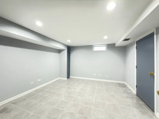 a backyard of a house with large trees and outdoor seating