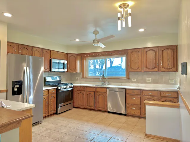 a kitchen with granite countertop stainless steel appliances and sink