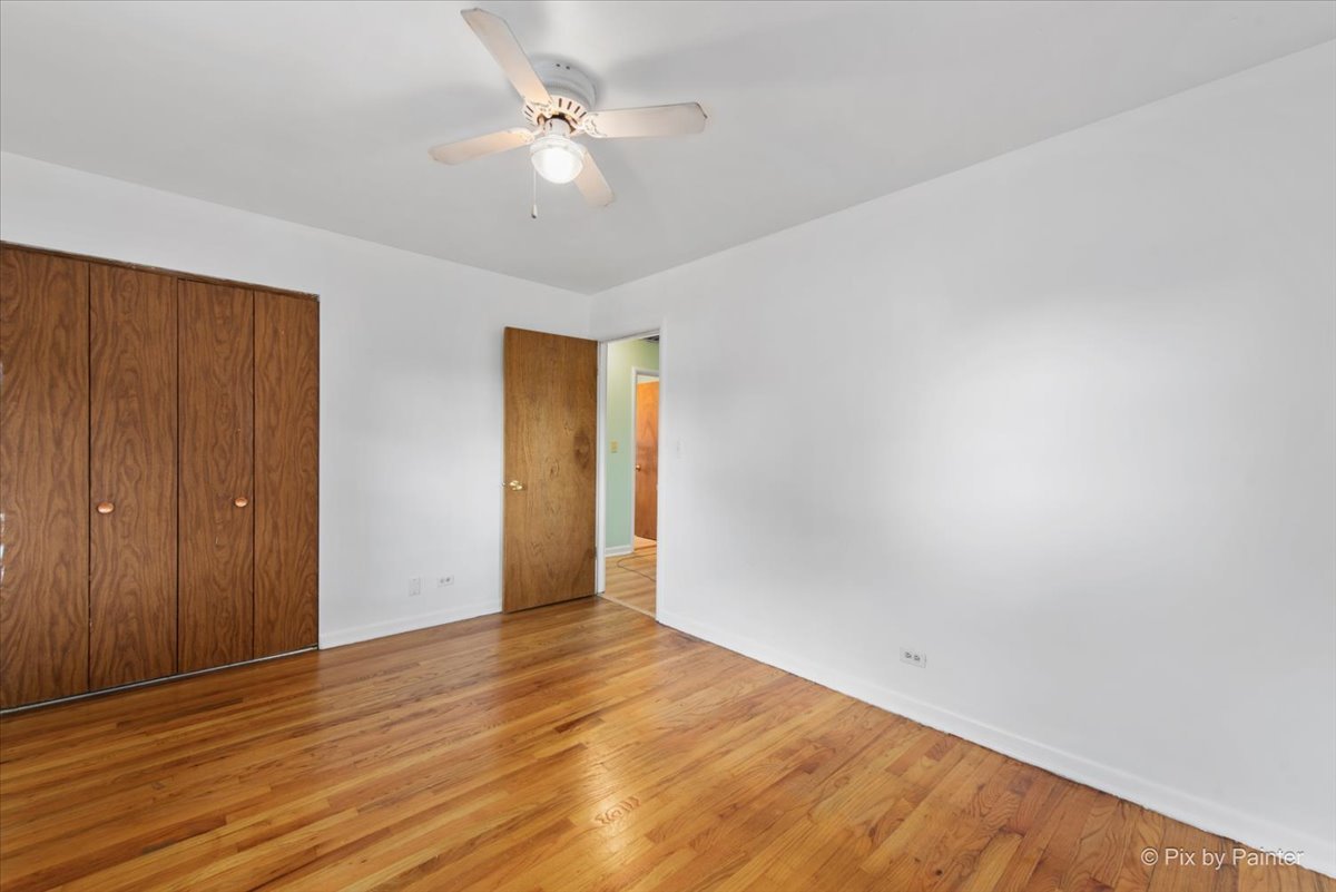 539 Rose Avenue Addison, IL 60101 - Photo 8 of 15 a view of an empty room with wooden floor