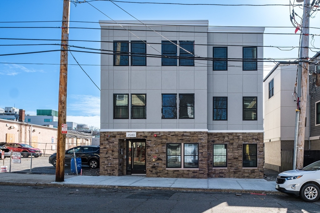 1540 North Shore Road, Unit 102 Revere, MA 02151 - Photo 14 of 14 a tall building with a outdoor space