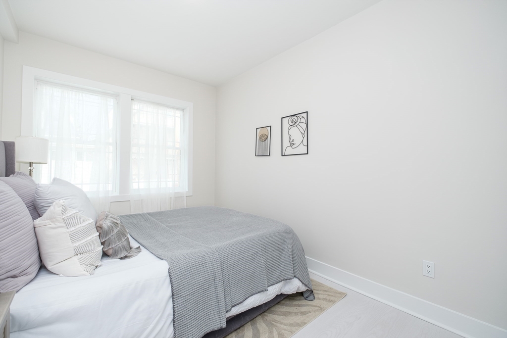 1540 North Shore Road, Unit 102 Revere, MA 02151 - Photo 3 of 14 a bedroom with a bed and a window