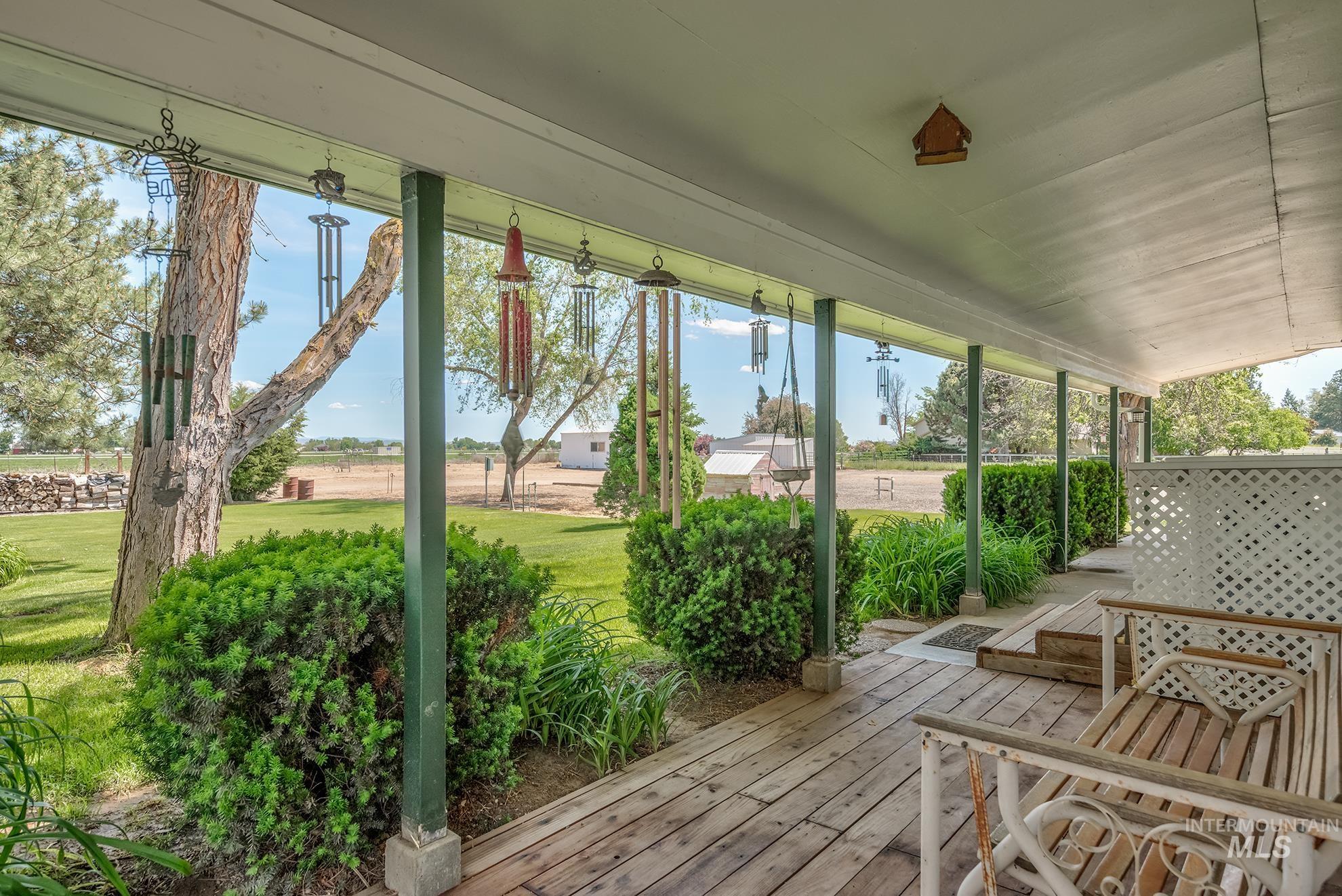 748 Pringle Road Weiser, ID 83672 - Photo 40 of 47 Expansive covered porch featuring a wood-finish floor, white lattice railing, and multiple support pillars