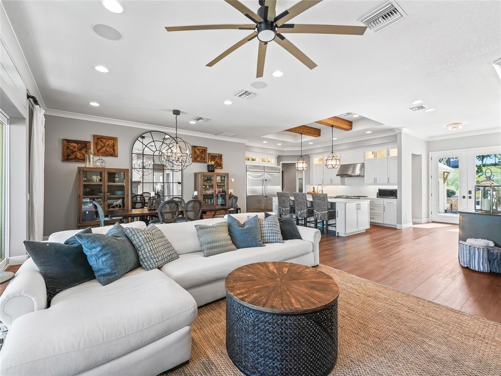 12943 Southeast Sunset Harbor Road Weirsdale, FL 32195 - Photo 14 of 87 a living room with furniture kitchen view and a wooden floor