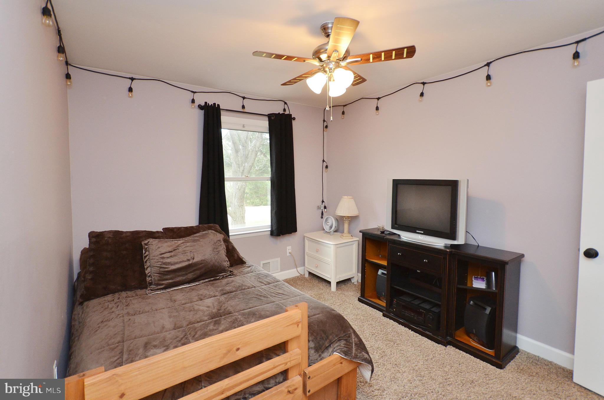 20952 Evergreen Mills Road Leesburg, VA 20175 - Photo 11 of 30 a bedroom with a bed and a flat screen tv