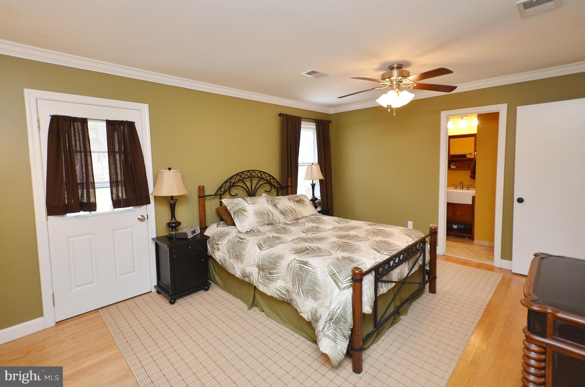 20952 Evergreen Mills Road Leesburg, VA 20175 - Photo 9 of 30 a bedroom with a bed and a chandelier