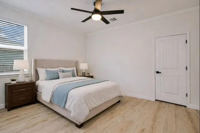 a bedroom with a bed and a chandelier
