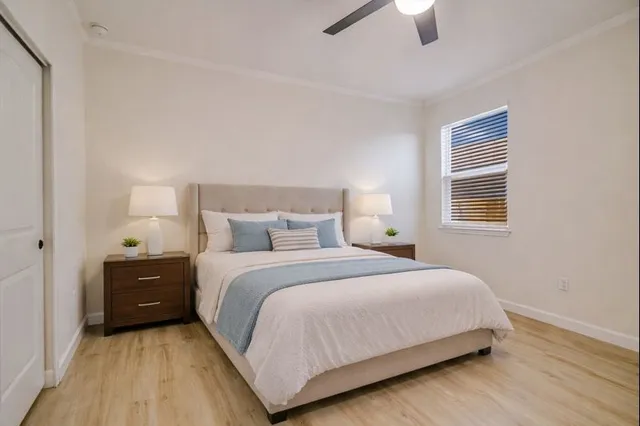 a bedroom with a bed and a chandelier