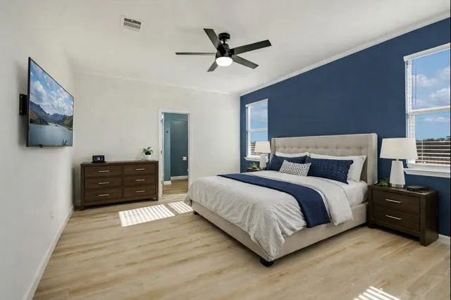 a bedroom with a bed and a flat screen tv