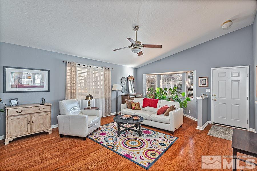 745 Talus Way Reno, NV 89503 - Photo 3 of 17 a living room with furniture a bed and a chandelier