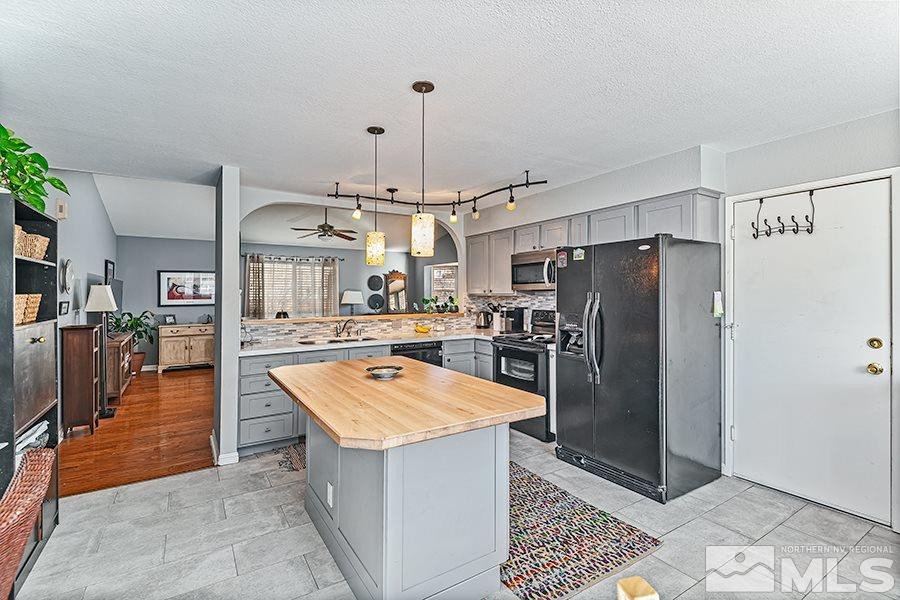 745 Talus Way Reno, NV 89503 - Photo 5 of 17 a kitchen with stainless steel appliances granite countertop a refrigerator a oven and a sink