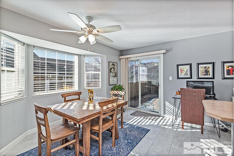 745 Talus Way Reno, NV 89503 - Photo 7 of 17 a dining room with furniture a chandelier and wooden floor