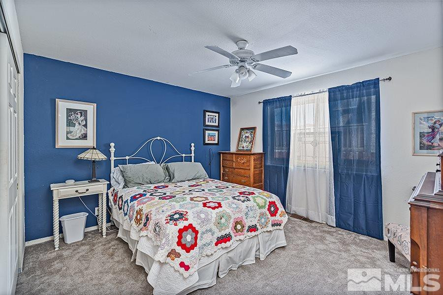 745 Talus Way Reno, NV 89503 - Photo 9 of 17 a bedroom with a bed and a chandelier