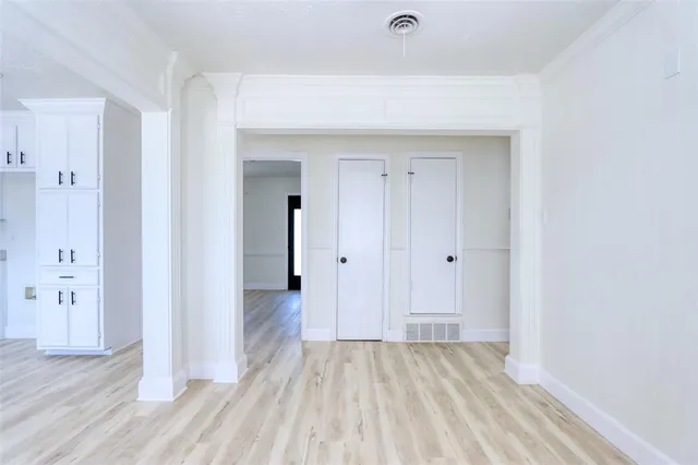 a view of a room with wooden floor