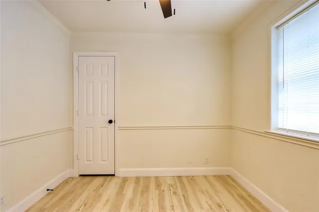 a view of a room with wooden floor and white walls