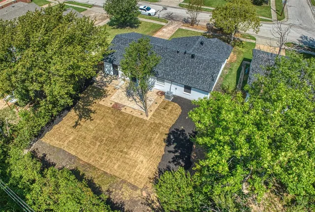 an aerial view of a house with a yard