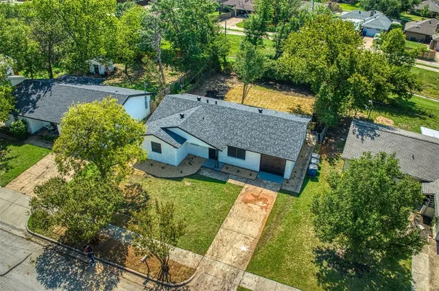 an aerial view of a house with a yard basket ball court and outdoor seating