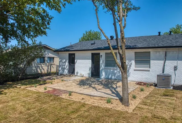 a view of a house with a tree in the background